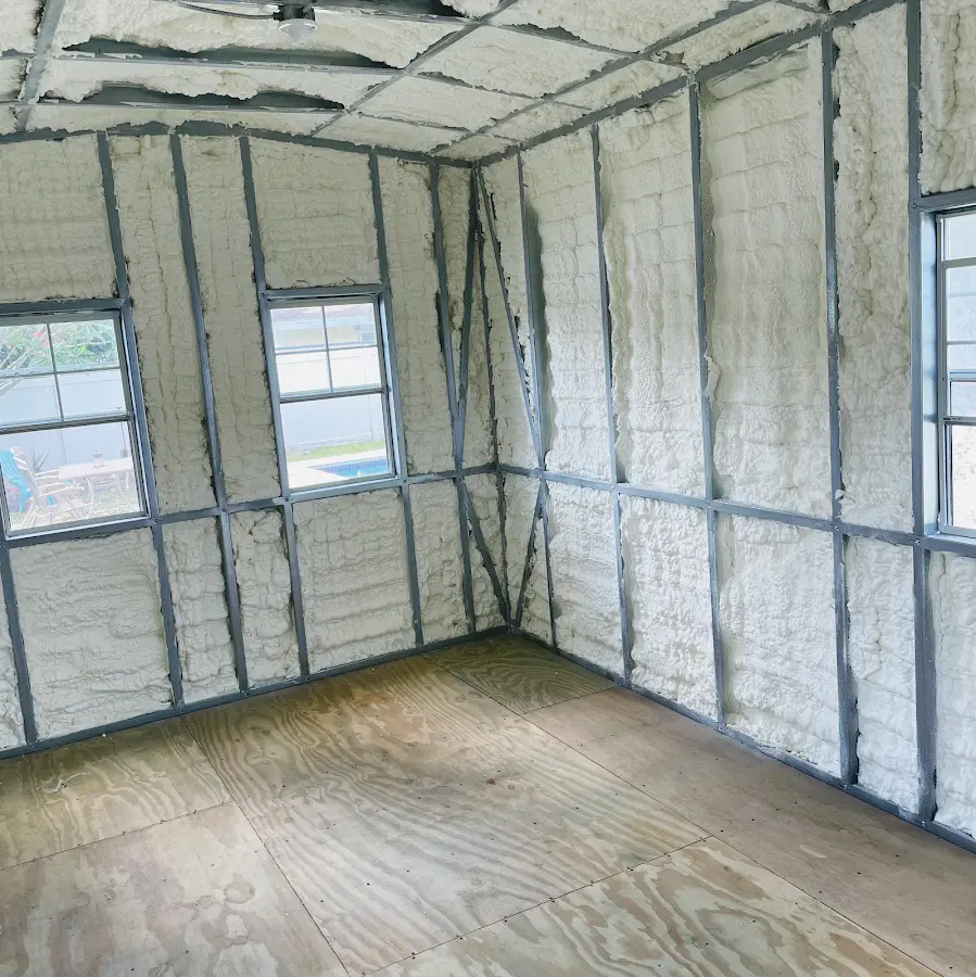 Closed-cell spray foam insulation applied to wall cavities in a residential project in Elsmere